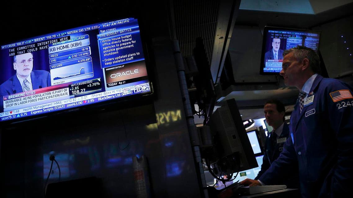 New York traders watch U.S. Federal Reserve Board Chairman Ben Bernanke’s news conference. (Reuters)