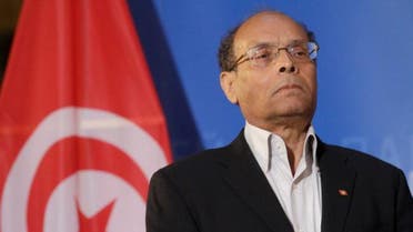 Tunisia's President Moncef Marzouki listens his national anthem at the European Parliament in Strasbourg, February 6, 2013. reu