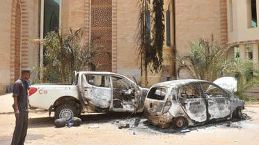 A man looks at burnt vehicles on Sept. 26, 2013 in the Sudanese capital Khartoum after rioting erupted following a decision of the government to scrap fuel subsidies. (AFP)