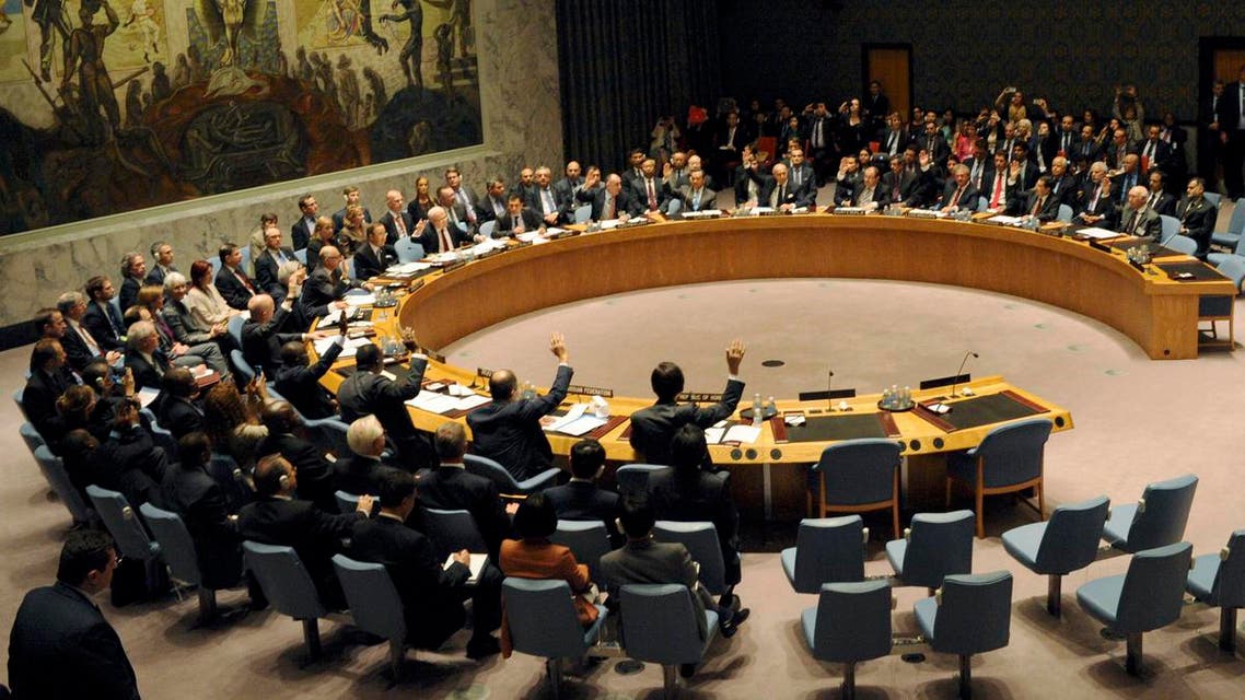 Members of the United Nations Security Council raise their hands as they vote unanimously to approve a resolution eradicating Syria's chemical arsenal during a Security Council meeting during the 68th United Nations General Assembly in New York on September 27, 2013.