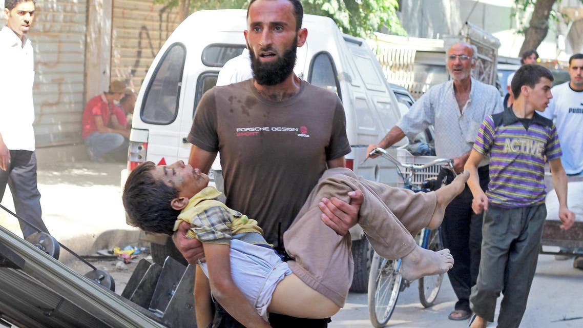 A man carries the body of a child allegedly killed by a pro-government forces sniper in the northern Syrian city of Aleppo on Oct. 2, 2013. (Reuters)