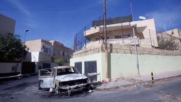  A damaged car is seen in front of the Russian embassy, a day after it came under attack in Tripoli October 3, 2013.