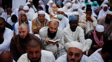 A Muslim pilgrim reads the Koran as he attends Friday prayers at the Grand mosque in the holy city of Mecca ahead of the annual haj pilgrimage October 11, 2013.