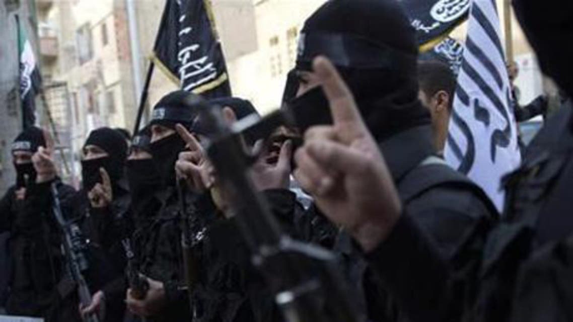 Members of an Islamist group hold their weapons during a protest in Deir el-Zor. (File photo: Reuters)
