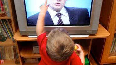 kid touches TV AFP generic