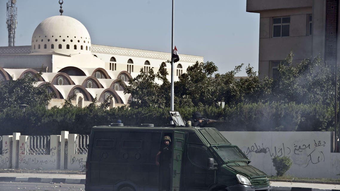 An Egyptian riot police van is seen during clashes with student of the al-Azhar University outside their university camps in Cairo, on October 20, 2013, during an anti-army protest. afp