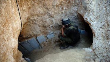 An Israeli soldier at the entrance of a tunnel reportedly dug by Palestinians beneath the border between the Gaza Strip and Israel and recently uncovered by Israeli troops, on October 13, 2013 (AFP/