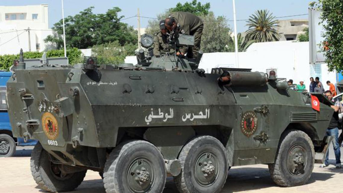unisian members of the national guard stand guard on their vehicle outside the Okba Ibn Nafaa mosque in the central Tunisian city of Kairouan on May 19, 2013 (File Photo)