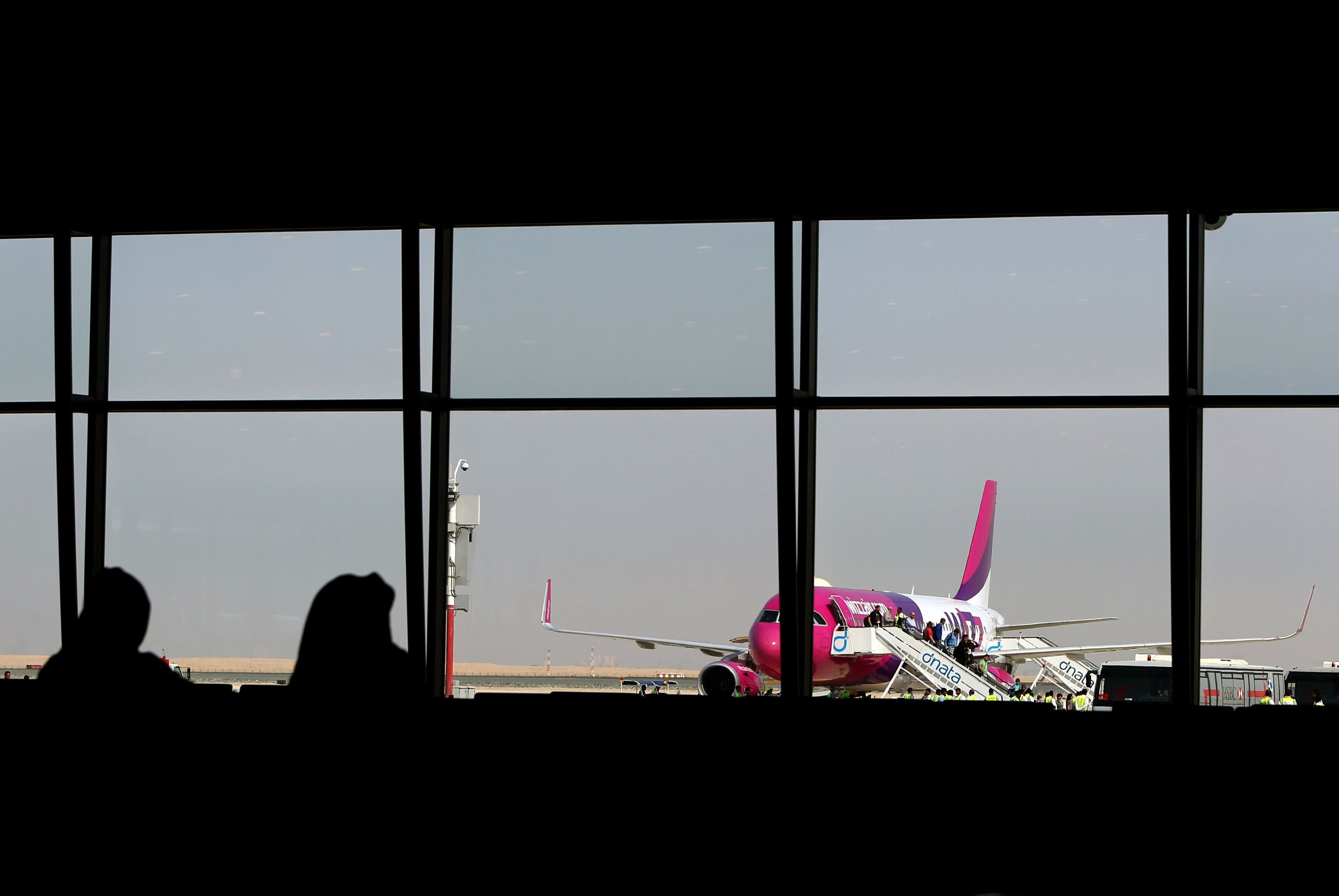 Passengers disembark from a Wizz Air flight at the newly opened Al-Maktoum International airport in Dubai, on October 27, 2013. (AFP)