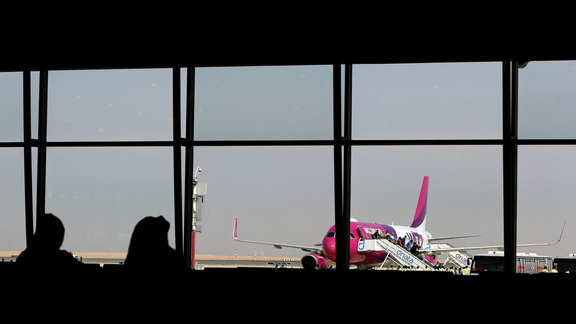 Passengers disembark from the low cost Hungarian Wizz Air at the newly opened Al-Maktoum International airport, the emirate's second airport in Dubai, on October 27, 2013. (AFP)