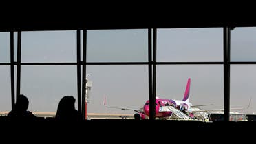 Passengers disembark from the low cost Hungarian Wizz Air at the newly opened Al-Maktoum International airport, the emirate's second airport in Dubai, on October 27, 2013. (AFP)