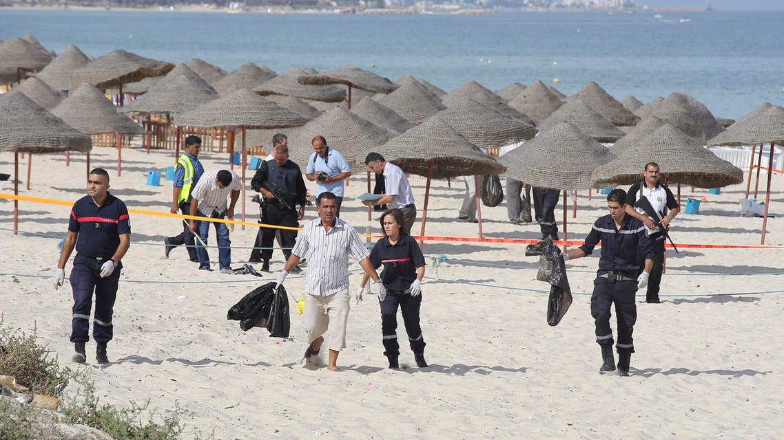 Tunisian policemen investigate near a crime scene on a beach near the tourist resort of Sousse Oct. 30, 2013. (Reuters)