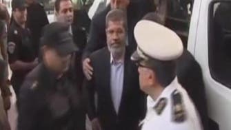 Egypt’s ousted President Mursi goes on trial and challenges the court