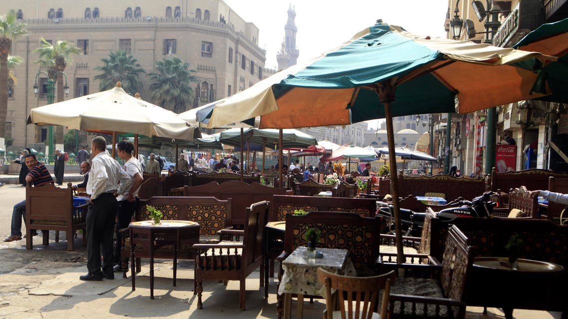 Coffee shop workers wait for customers near empty chairs in front of a popular tourist area in old Cairo. (File photo: Reuters)