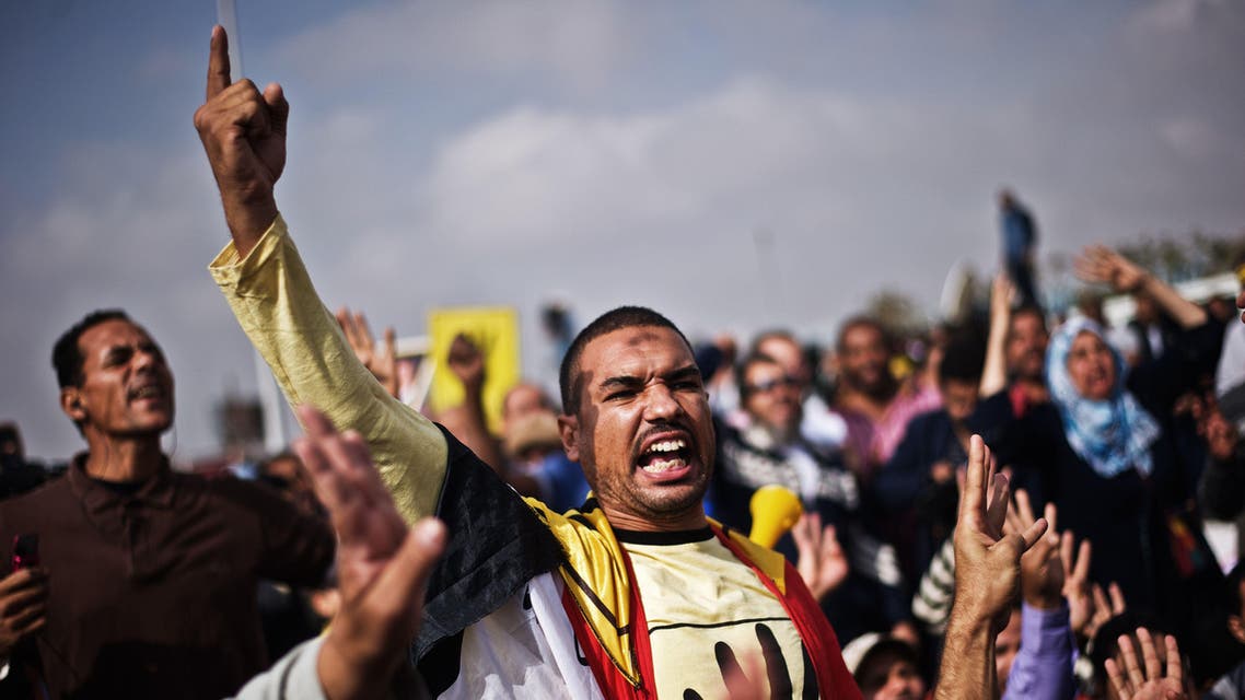 Muslim Brotherhood and supporters of ousted president Mohamed Morsi shout slogans in his support outside the Police Academy where his trial is taking place on November 4, 2013, in Cairo. (AFP)