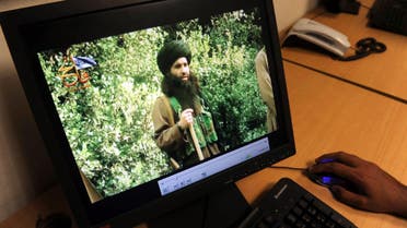 A Pakistani journalist watches a newly released video of radical Pakistani cleric Maulana Fazlullah in Peshawar. (AFP)