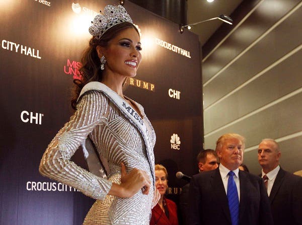 Miss Venezuela Gabriela Isler poses for photographers as Donald Trump (2nd R), co-owner of the Miss Universe Organization, looks on at a news conference after Isler won the Miss Universe 2013 pageant at the Crocus City Hall in Moscow Nov. 9, 2013.  (Reuters)