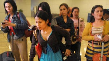 Some of the 30 repatriated Filipino workers arrive at Manila airport. Photo: AFP
