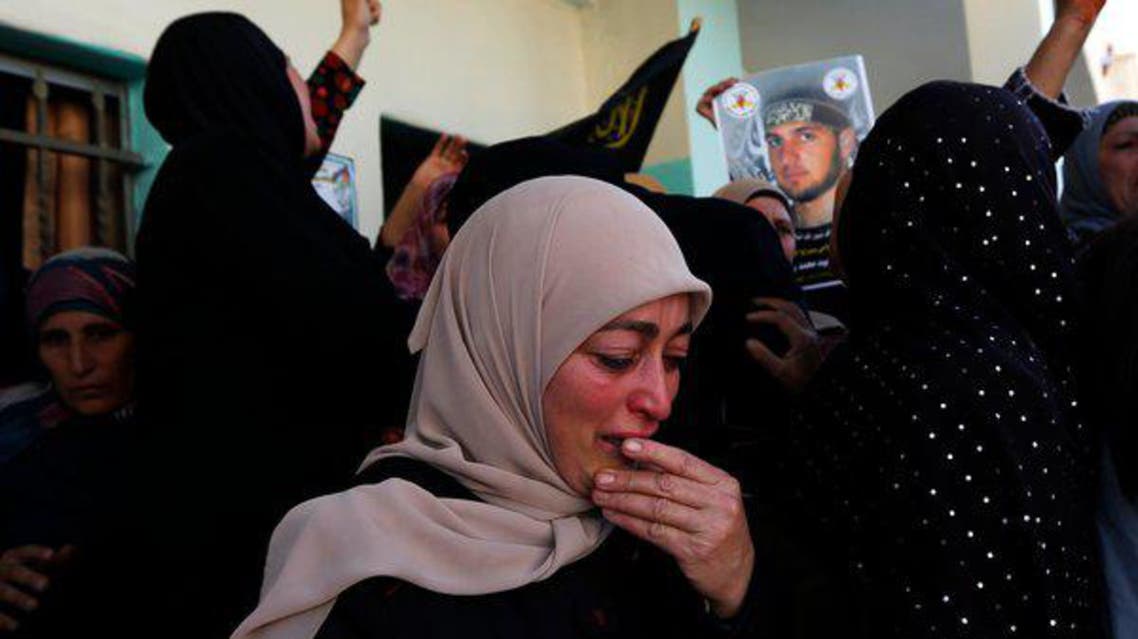Palestinian mourners seen at the funeral of Mohammed Assi in Beit Liqya, a village near Ramallah, the West Bank. (Reuters)