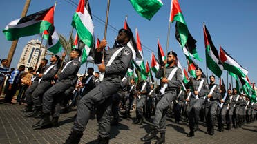 Members of Palestinian security forces loyal to Hamas hold national flags as they march on a street in Gaza City ahead of the first anniversary of the eight-day conflict with Israel Nov. 13, 2013. (Reuters)