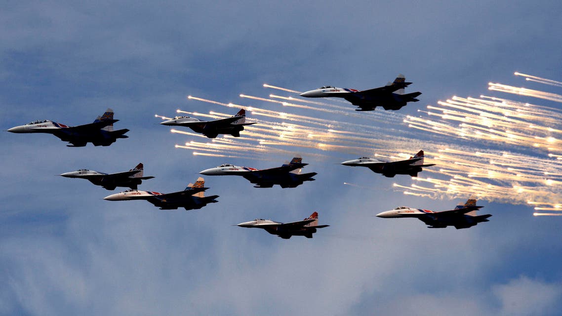 MiG-29 jet fighters from the Strizhi (Swifts) and Sukhoi Su-27 jet fighters from the Russkiye Vityazi (Russian Knights) aerobatic teams fly past during the International Naval Show in St.Petersburg, June 25, 2009. (Reuters)