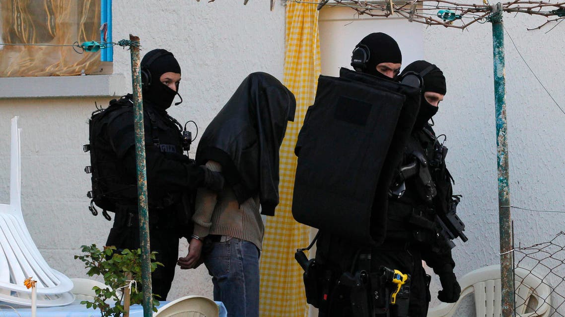 Masked special forces police escort a member of the Islamist community under heavy guard in Coueron, near Nantes, March 30, 2012. (File Photo: Reuters)