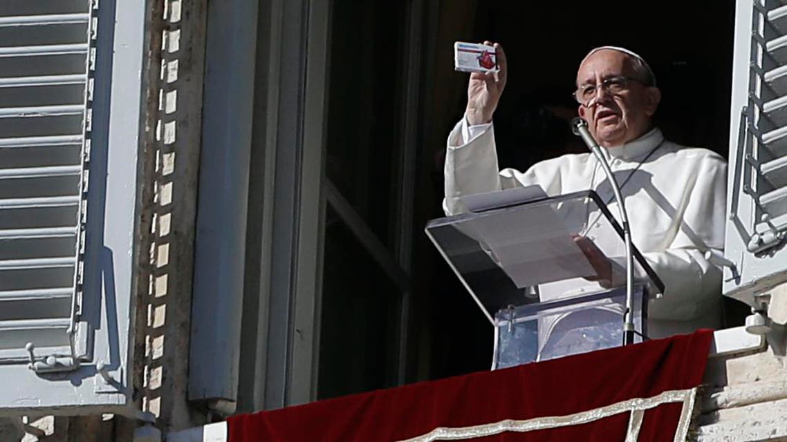 Pope Francis shows a box shaped like a pill box but which contains a rosary during his traditional Sunday appearance in St. Peter's Square at the Vatican, Sunday, Nov. 17, 2013.