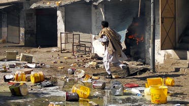 A man runs past burning shops after a market was set on fire during sectarian clashes in Kohat, Khyber Pakhtunkhwa province November 18, 2013. (Reuters)