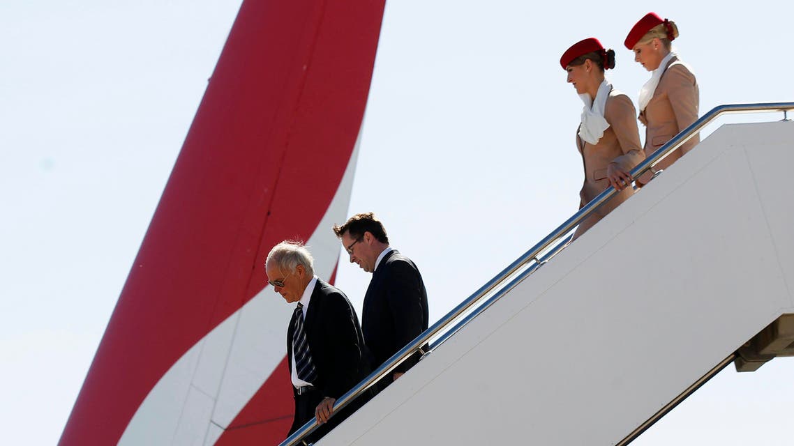 Qantas Chief Executive Officer Alan Joyce (2nd L) and Emirates President Tim Clark (L) descend from an Emirates A380