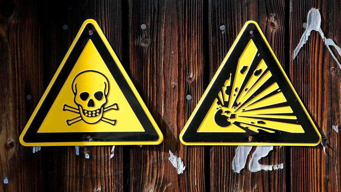 Warning signs hang on a wall at chemical weapons destruction site at the Society for the Disposal of Chemical Weapons and Ordnance (GEKA) in Munster October 14, 2013. reuters