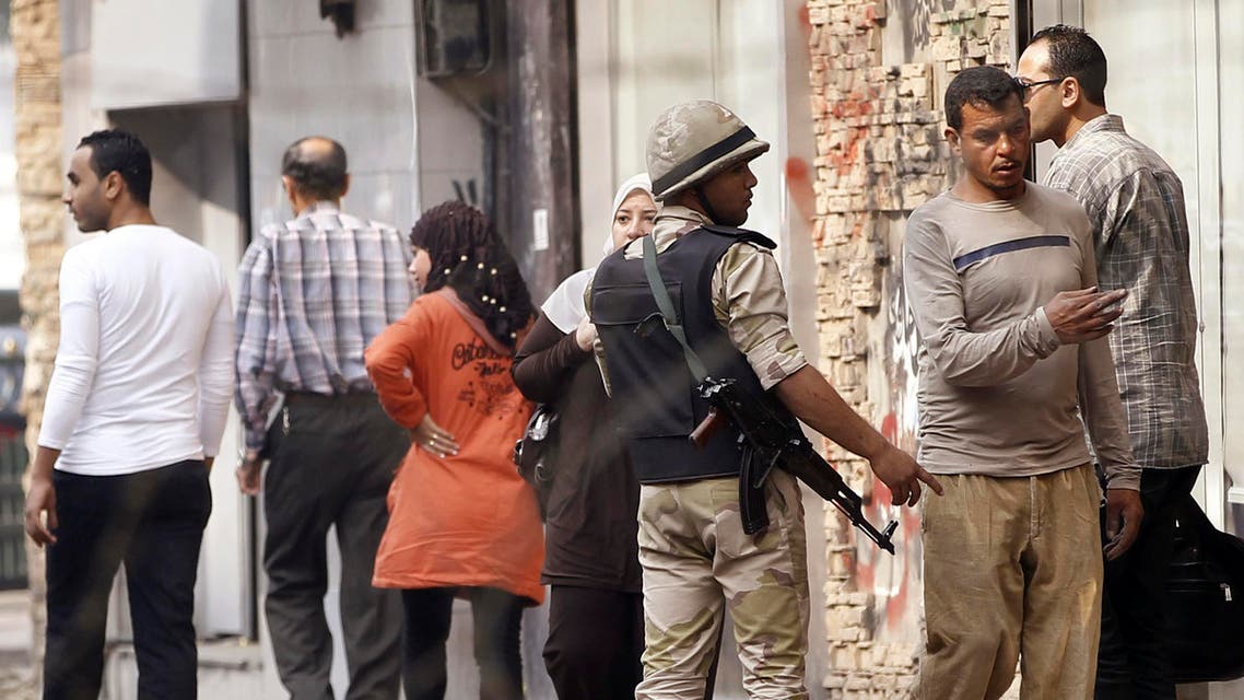 An armed soldier redirects people following the closure of Tahrir Square after night clashes in Cairo, Nov. 20, 2013. (Reuters)