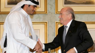 FIFA President Sepp Blatter (R) shakes hands with Qatar's 2022 World Cup Bid Chief Sheikh Mohammed Al-Thani (L) at a news conference in Doha Nov. 9, 2013. (Reuters)