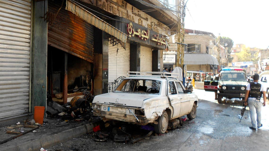 A Lebanese solider walks past a damaged car a day after clashes in Baalbek, in Lebanon's Bekaa Valley September 29, 2013. (Reuters)
