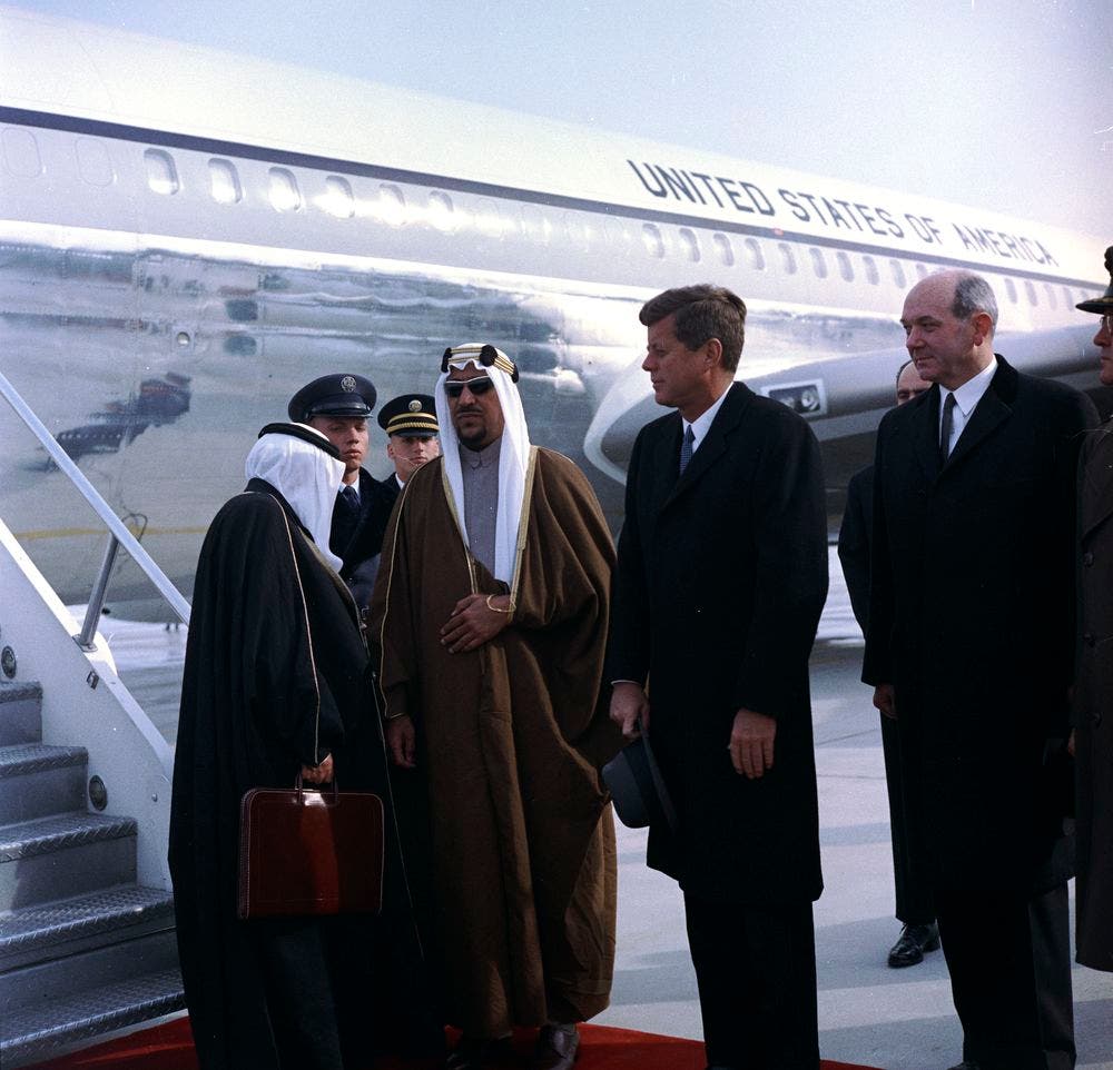 President John F. Kennedy and Secretary of State Dean Rusk welcome King of Saudi Arabia Saud bin Abdul-Aziz Al Saud (wearing sunglasses) at Andrews Air Force Base, Maryland on Feb. 13, 1962. (Photographer: Robert LeRoy. Via: www.jfklibrary.org)