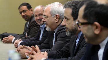 Iranian Foreign Minister Mohammad Javad Zarif (C) attends talks flanked by members of his delegation during talks over Iran's nuclear programme in Geneva on Nov. 22, 2013. (AFP)