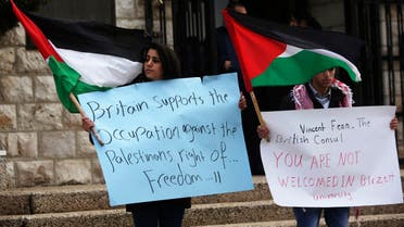Palestinian students protest against the visit of British Consul-General Sir Vincent Fean (not seen) to a university in the West Bank city of Ramallah in March 2013. (File photo: Reuters)