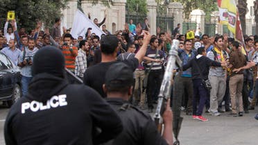 Students of Cairo University shout slogans against the military and interior ministry during a demonstration at the main gate of the university in Cairo, Nov. 24, 2013. (Reuters) 