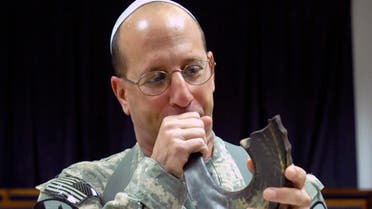 Col. Steven Bernstein, from St. Louis, Mo. sounds the ram's horn, also known as a shofar in Hebrew, after a Rosh Hashanah service at Victory Base Complex (VBC) in Baghdad's international airport Sept. 18, 2009. (Reuters)