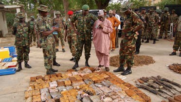 Military officials stand near ammunitions seized from suspected members of Hezbollah after a raid of a building in Nigeria's northern city of Kano May 30, 2013.  (Reuters)