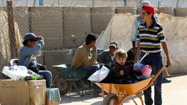 Syrian refugee children workers sit in wheelbarrows as they wait for customers at Al Zaatari refugee camp in the Jordanian city of Mafraq near the border with Syria November 20, 2013. reuters
