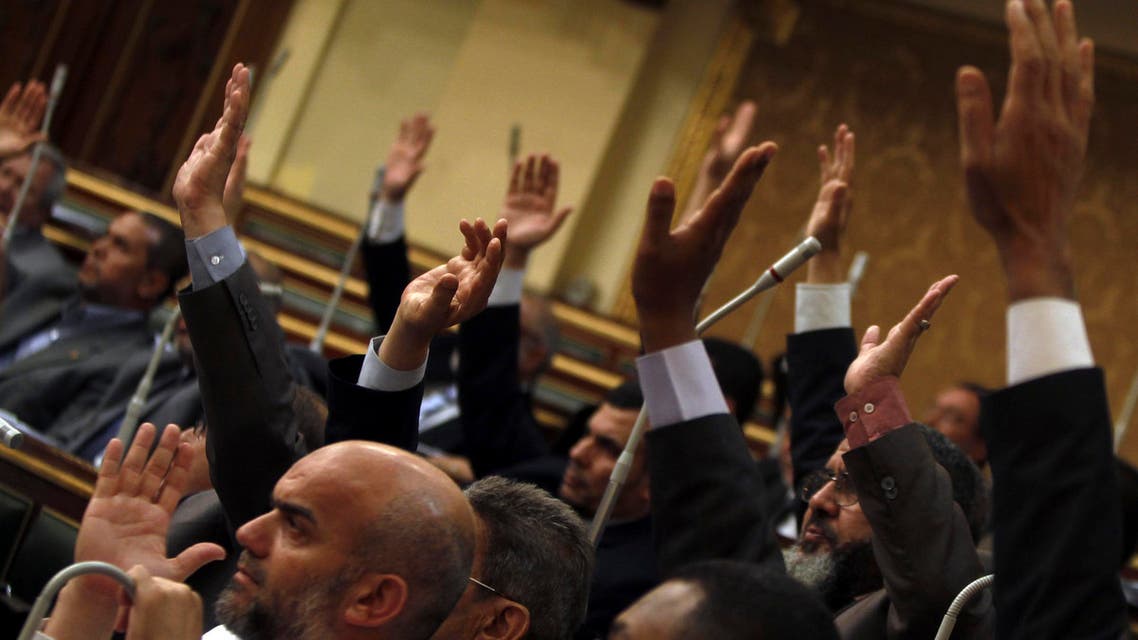 A file photo shows Islamists and members of the Muslim Brotherhood in the Shura Council, raise their hands to approve a law earlier this year. (File photo: Reuters)