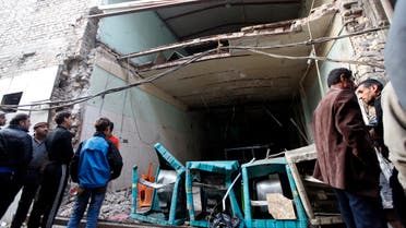 Residents look at the site of bomb attacks at a cafe in Baghdad's Sadriya district Reuters