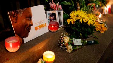 Mourners commemorate the death of Nelson Mandela