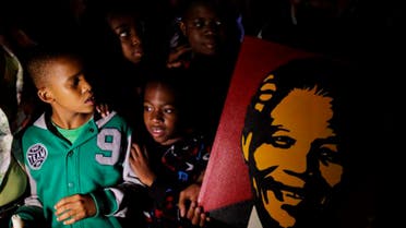 Mourners commemorate the death of Nelson Mandela
