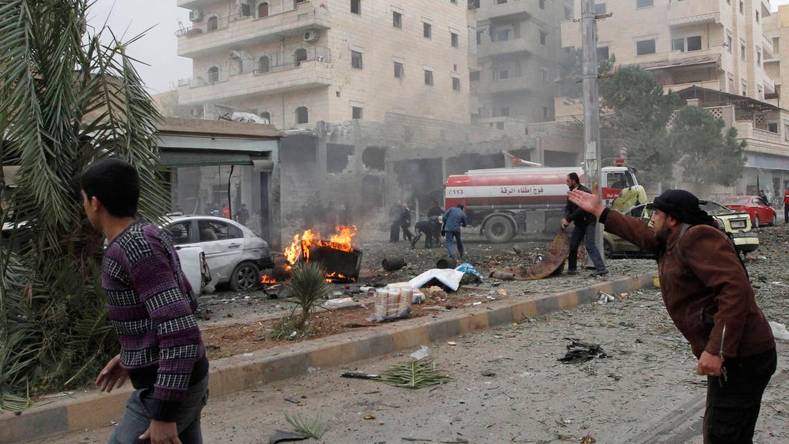 A man gestures at a site hit by what activists say was an air raid from forces loyal to Syria's President Bashar al-Assad in Raqqa, eastern Syria Dec. 7, 2013. (Reuters)