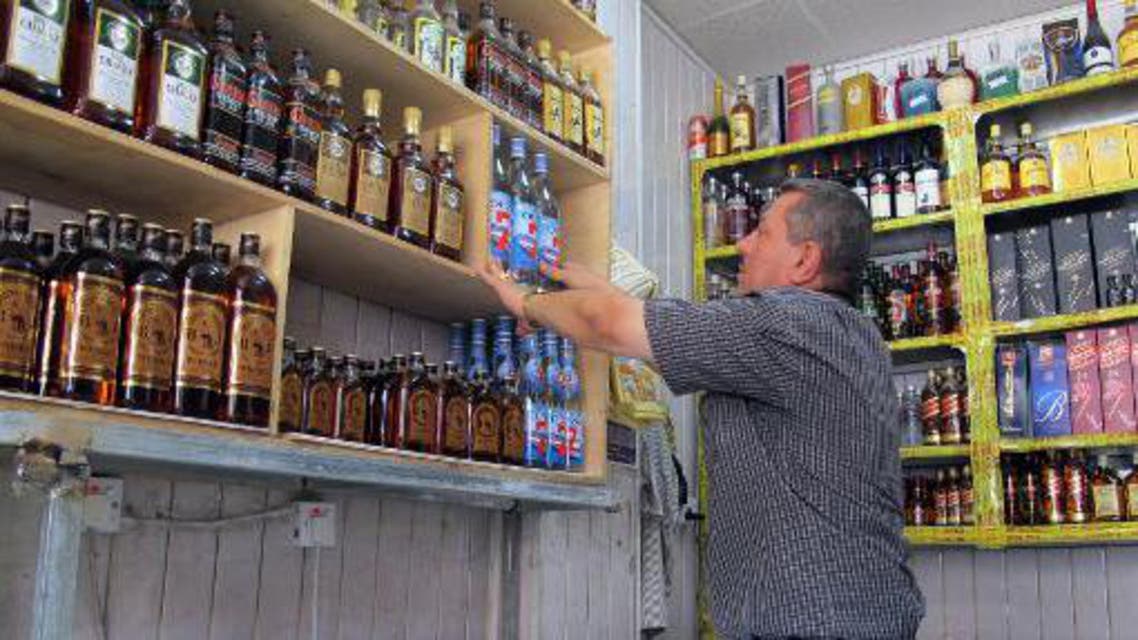 A shopkeeper arranges bottles in a shop in the Zayouna area of the Iraqi capital Baghdad, on May 15, 2013