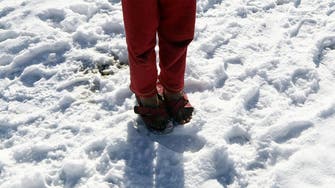 Syrian refugees smile despite heavy snowfall