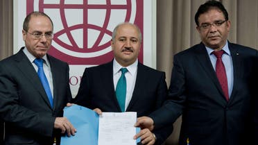 Israeli Regional Development Minister Sylvan Shalom (L), Jordanian Water and Agriculture Minister Hazem Nasser (C) and Shaddad Attili, head of the Palestinian Water Authority, pose at the World Bank in Washington, DC, after signing a water agreement Dec. 9, 2013. (AFP)