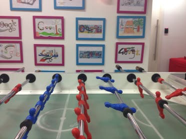 Google ‘doodle’ submissions hang on the wall over a foosball table. (Al Arabiya)