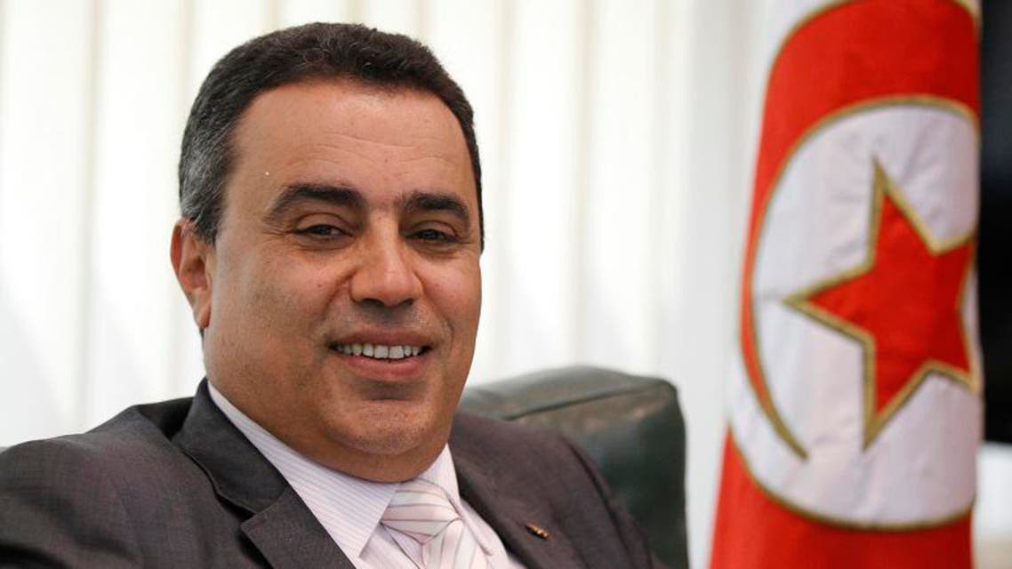 Tunisia's Industry Minister Mehdi smiles in his office in Tunis in this June 25, 2013 file photo. (Reuters)
